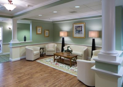 Well lit lobby area with bannisters and recessed lighting