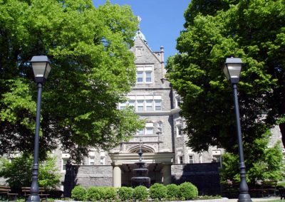 View of fountain and lush trees in front of Olde Main