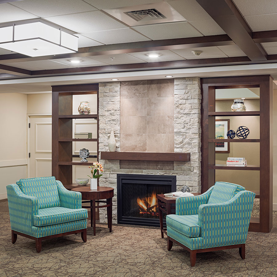 2 blue chairs in front of fireplace in Philadelphia independent living apartment building